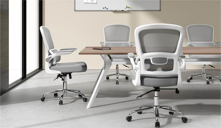 It's a meeting room with 4 white and grey ergonomic chairs and a meeting desk. 