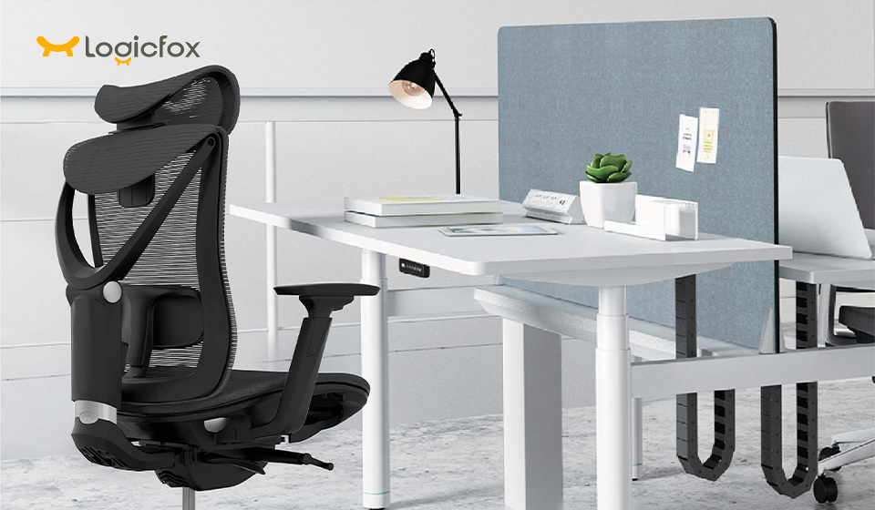 a black mesh ergonomic chair with adjustable armrest, with a office computer desk, and a lamp on the deks.